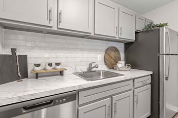 Shaker style white cabinetry w/ modern hardware